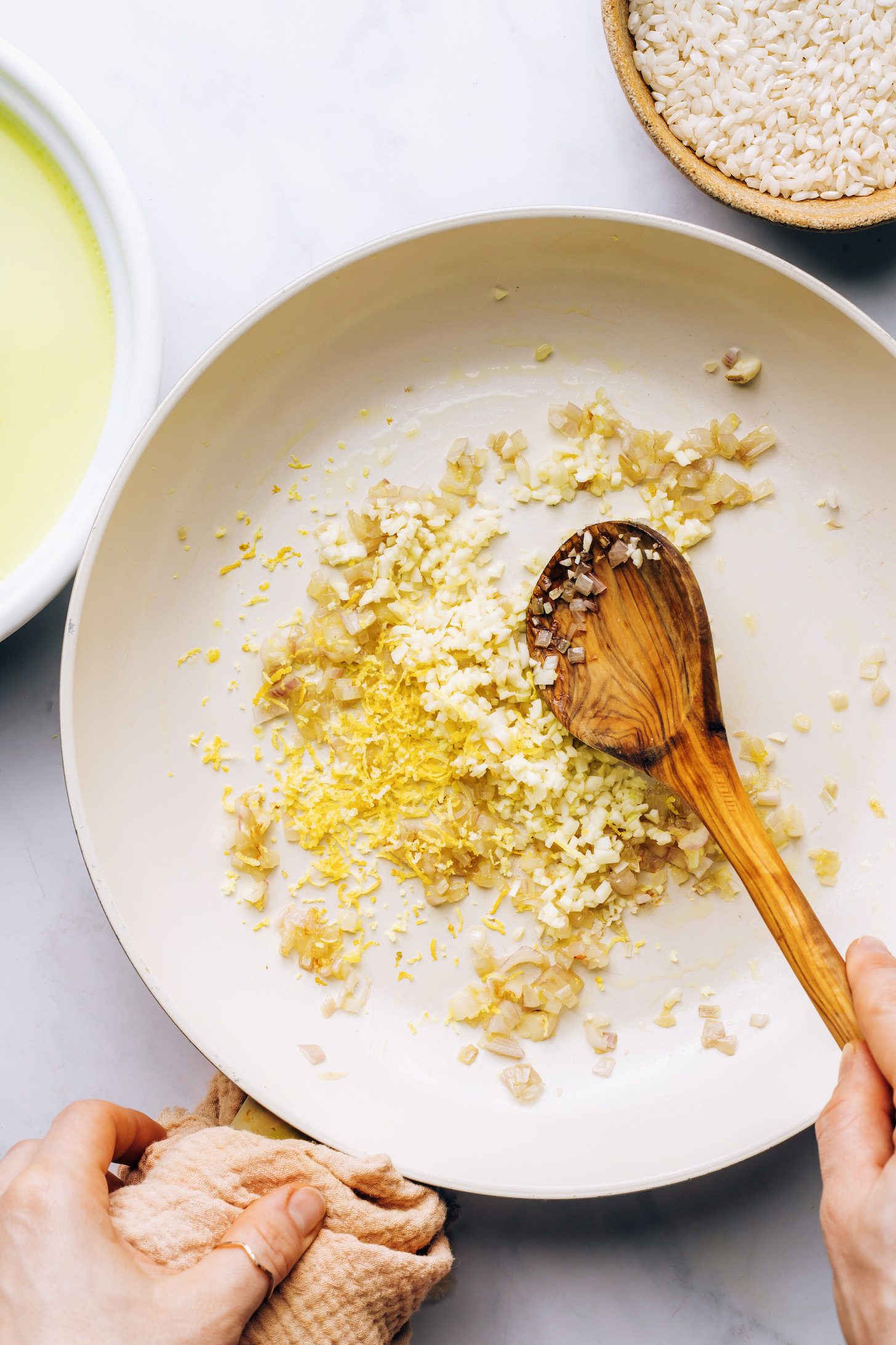 Sautéing garlic, shallots, and lemon zest in vegan butter