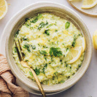 Overhead shot of a bowl of lemon risotto topped with fresh herbs
