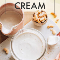 Jar of cashew cream with pieces of cashew surrounding