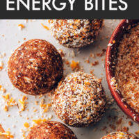 Vegan, gluten-free, no-bake orange cardamom energy bites being rolled in toasted coconut