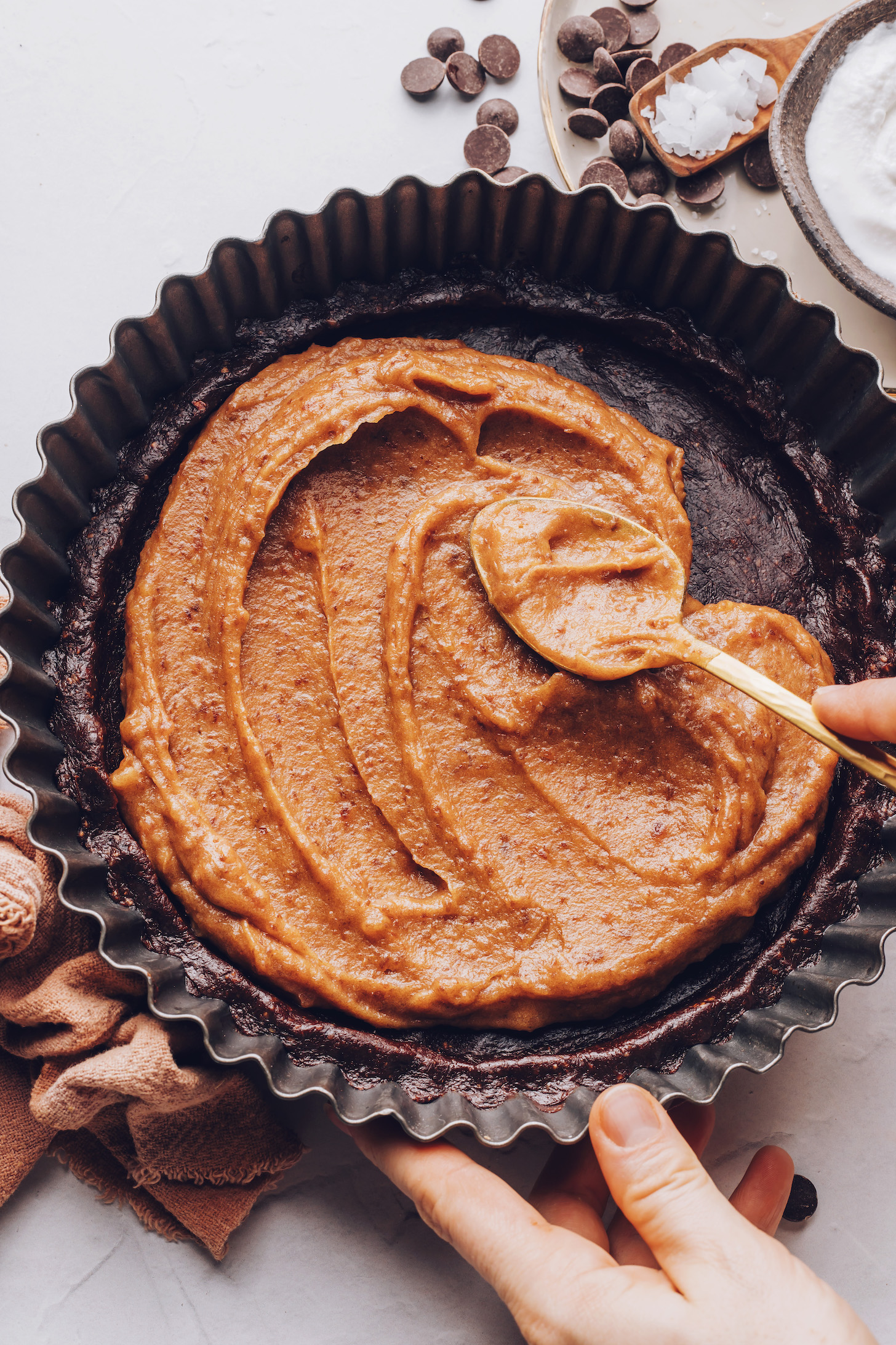 Spreading date-sweetened salted caramel over a chocolate crust