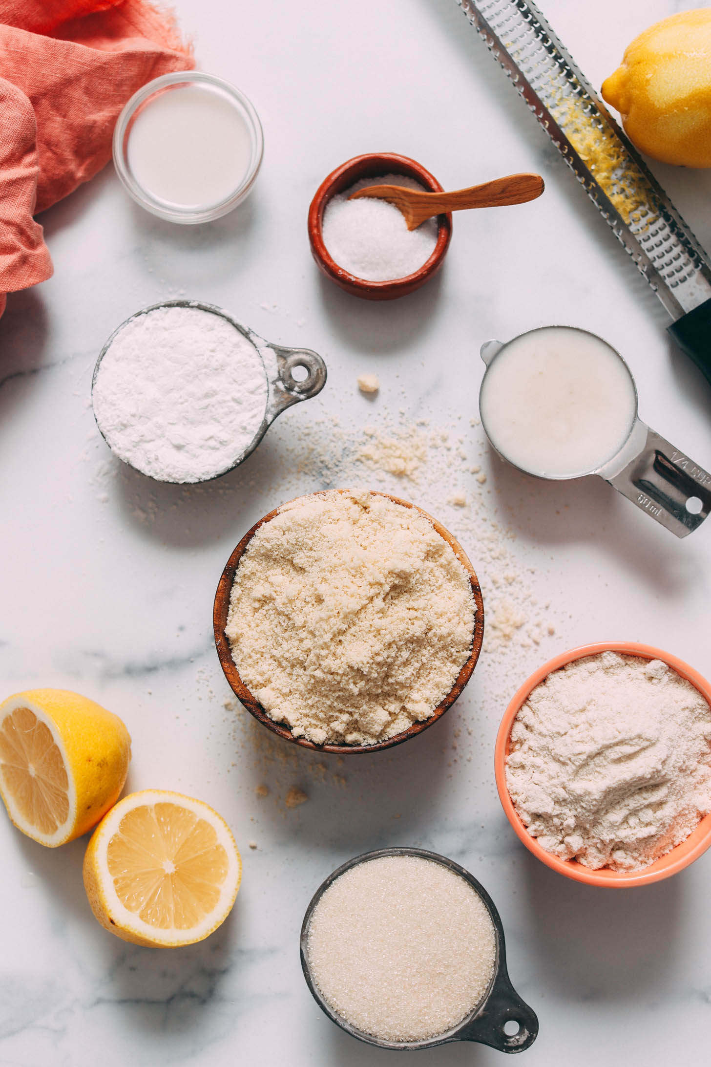 Gluten-free flours, almond milk, lemon zest, powdered sugar, cane sugar, lemons, and salt