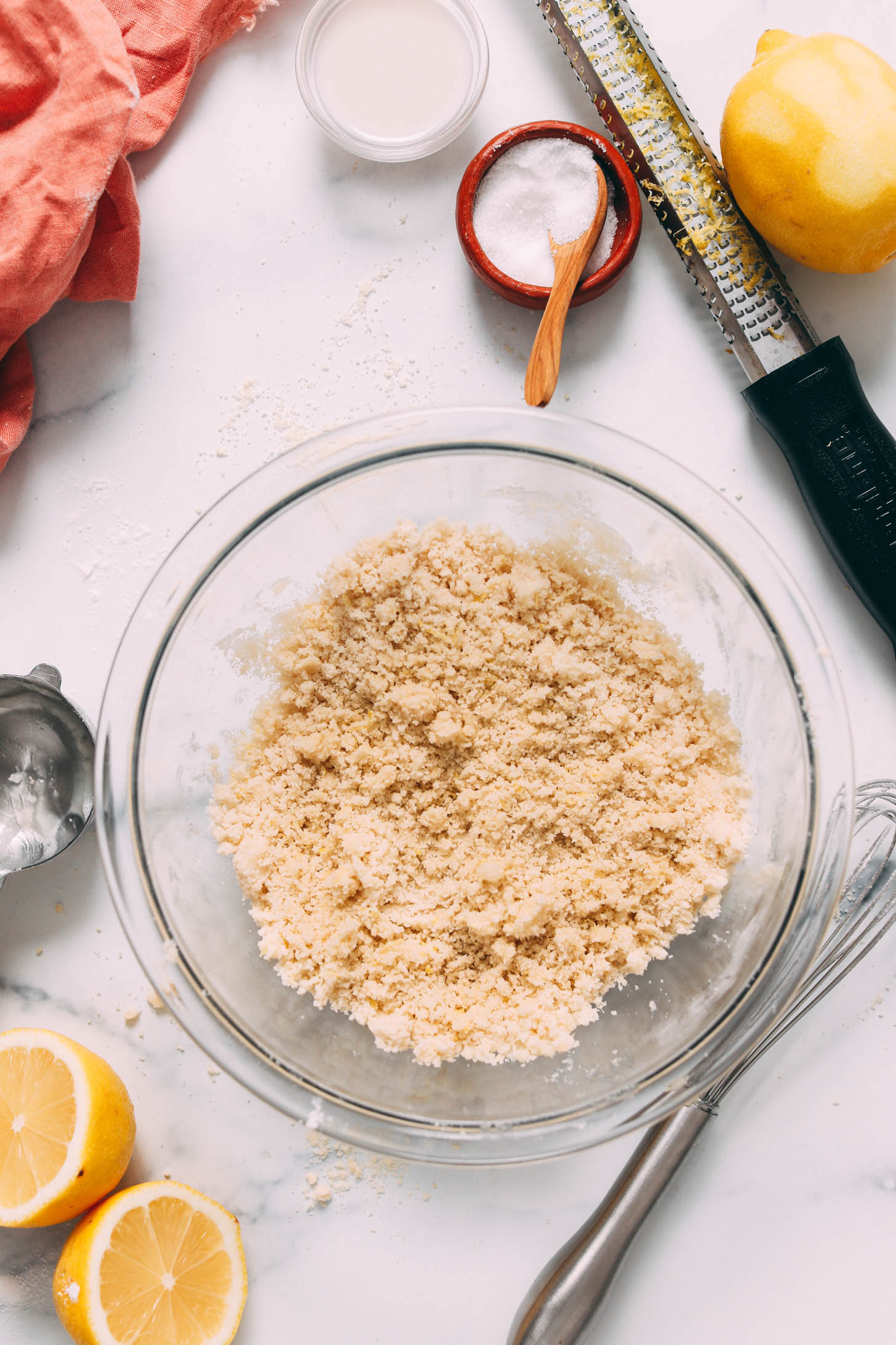 Lemon cookie dough in a glass mixing bowl