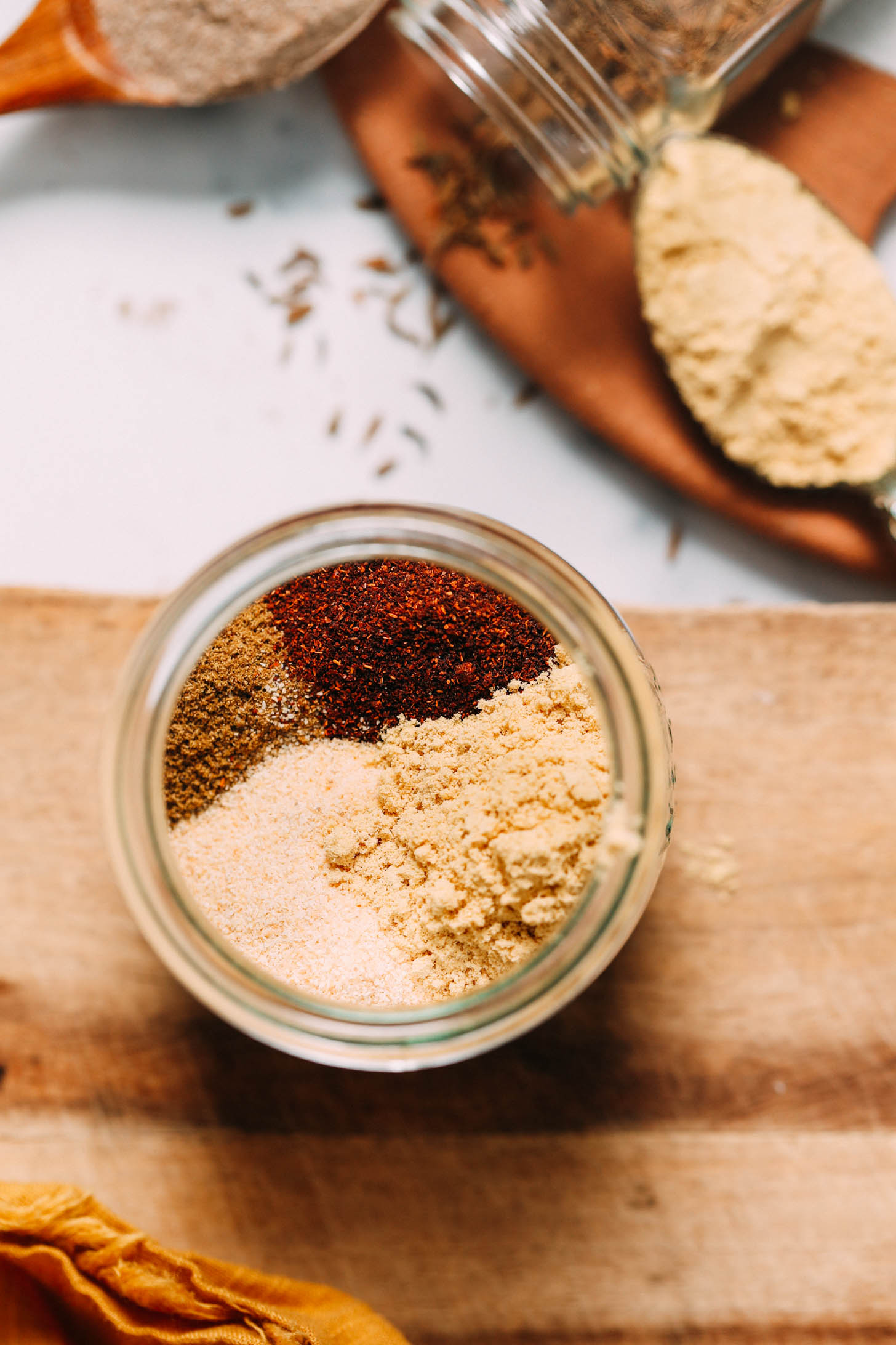 Cumin, paprika, garlic, ginger, coriander, and cardamom in a jar