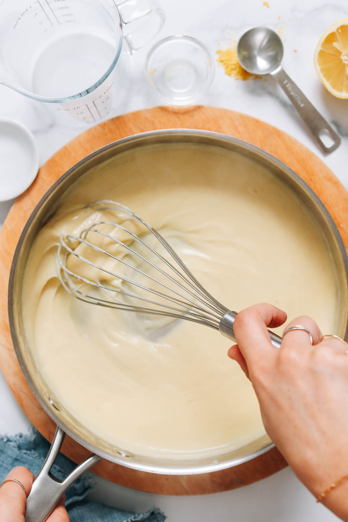 Whisking vegan hollandaise sauce in a skillet