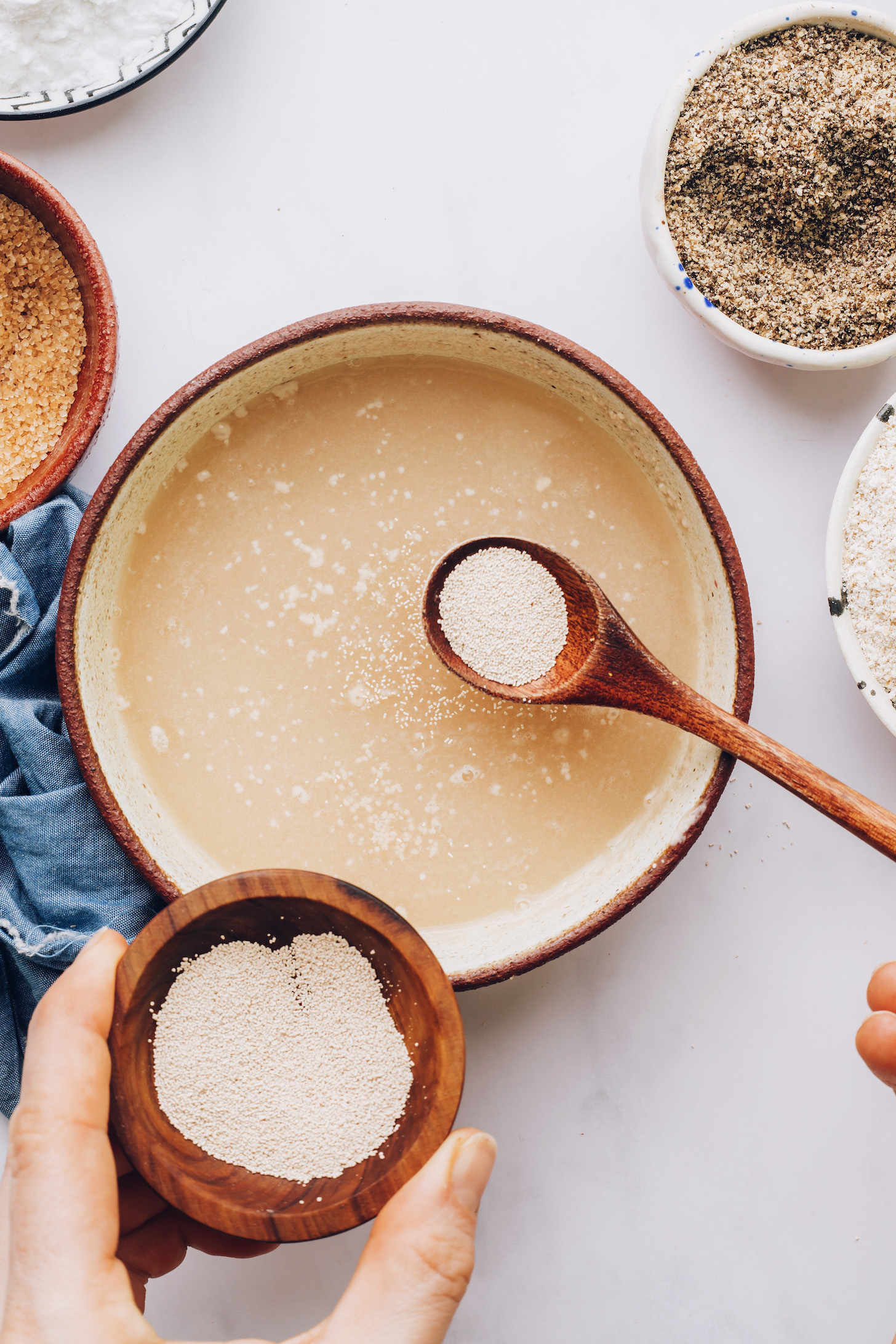 Adding yeast to bowl of warm water