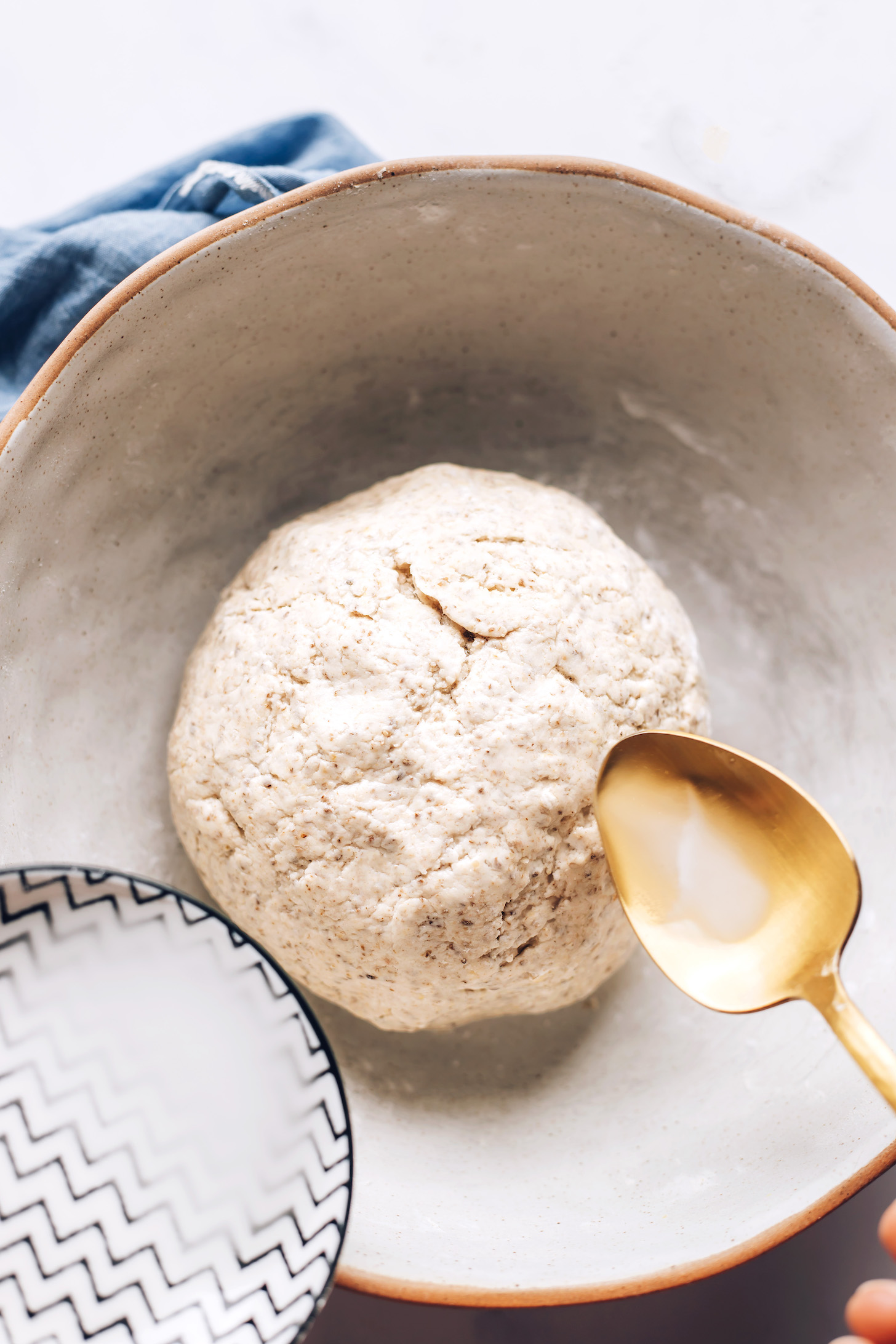 Adding a baking powder and water mixture to risen dough to give it even more lift