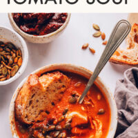Bowl of vegan and gluten-free 1-pot chipotle tomato soup with a piece of bread in it
