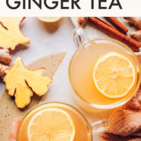 Mugs of fresh ginger tea with lemon slices on top