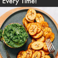 Plate of roasted plantains with green chutney on the side