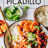 Bowl of easy vegan and gluten-free Cuban-inspired picadillo with plantains on the side