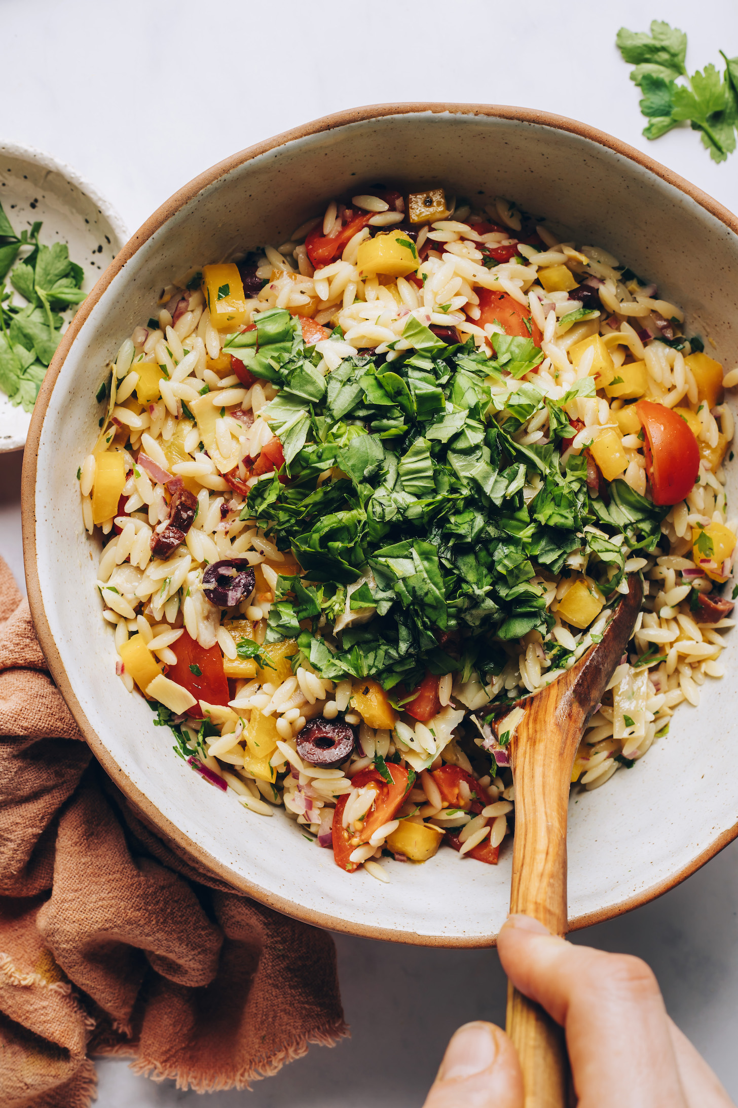 Freshly chopped basil over orzo pasta salad