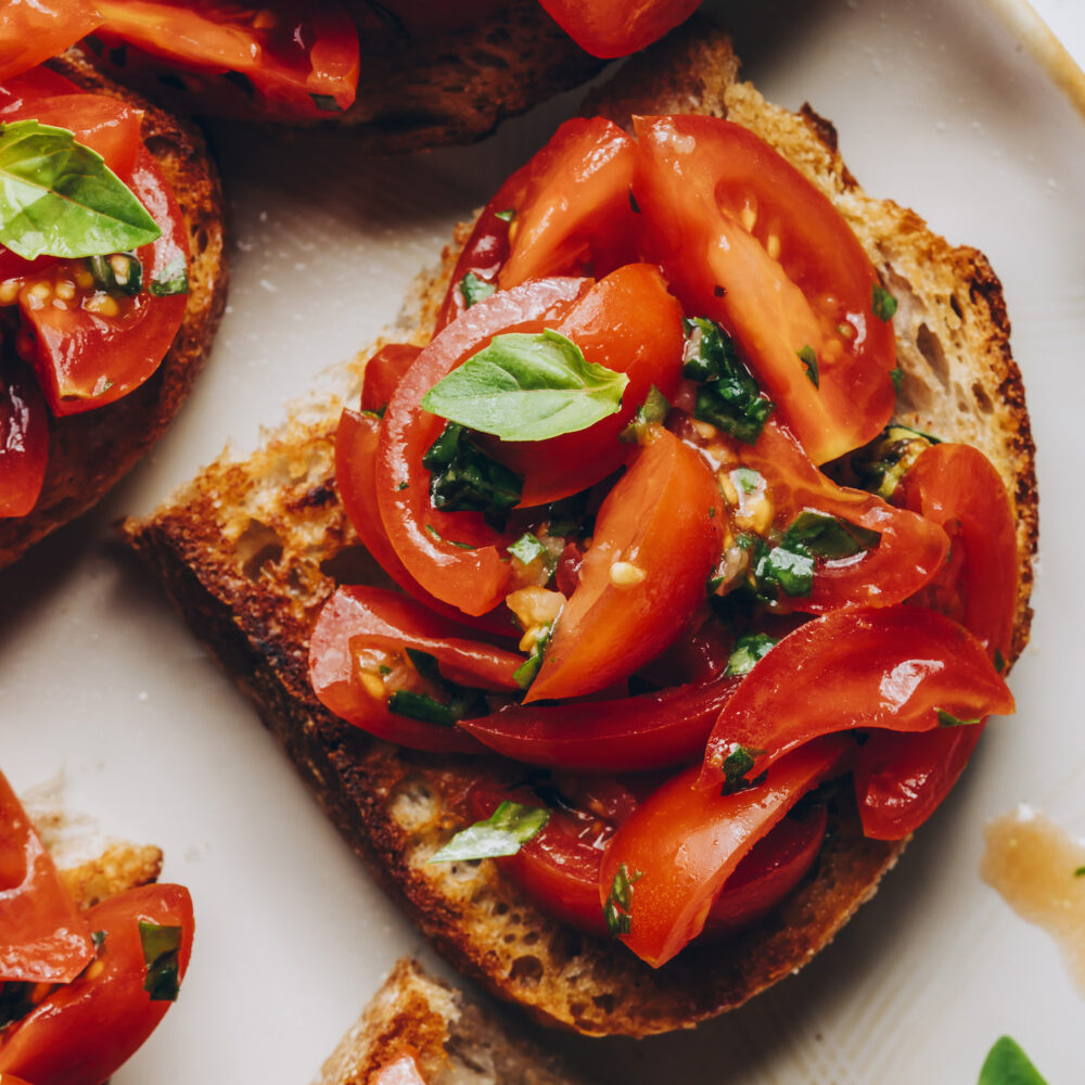 Close up shot of a slice of vegan cherry tomato bruschetta