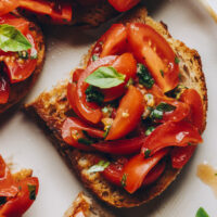 Close up shot of a slice of vegan cherry tomato bruschetta