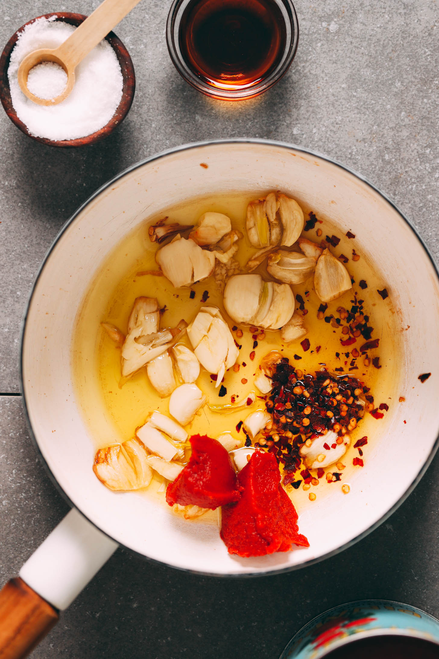 Smashed garlic, red pepper flakes, and tomato paste in olive oil