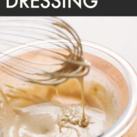Whisk whisking a bowl of vegan and gluten-free tahini dressing