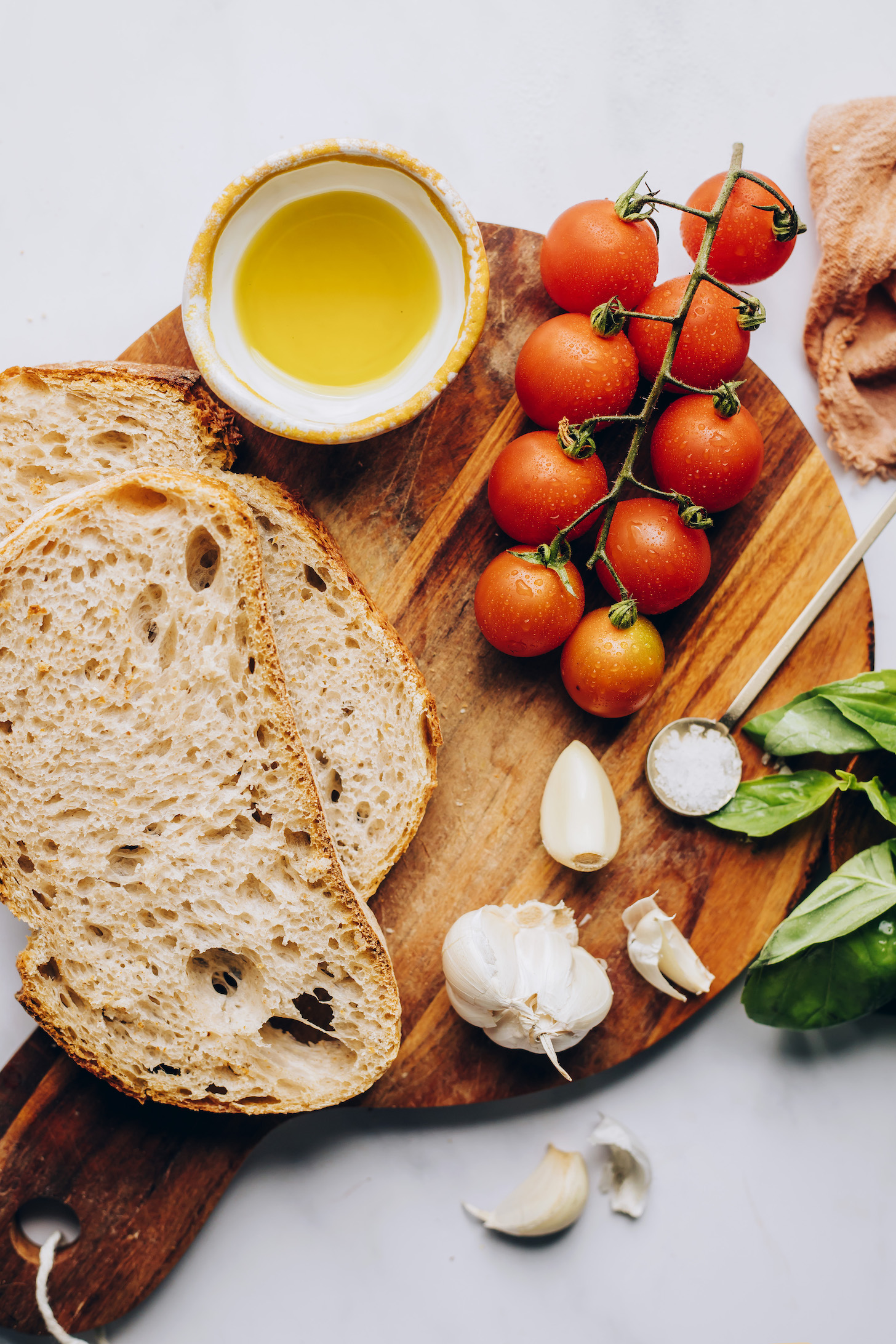 Sliced bread, olive oil, cherry tomatoes, basil, salt, and garlic