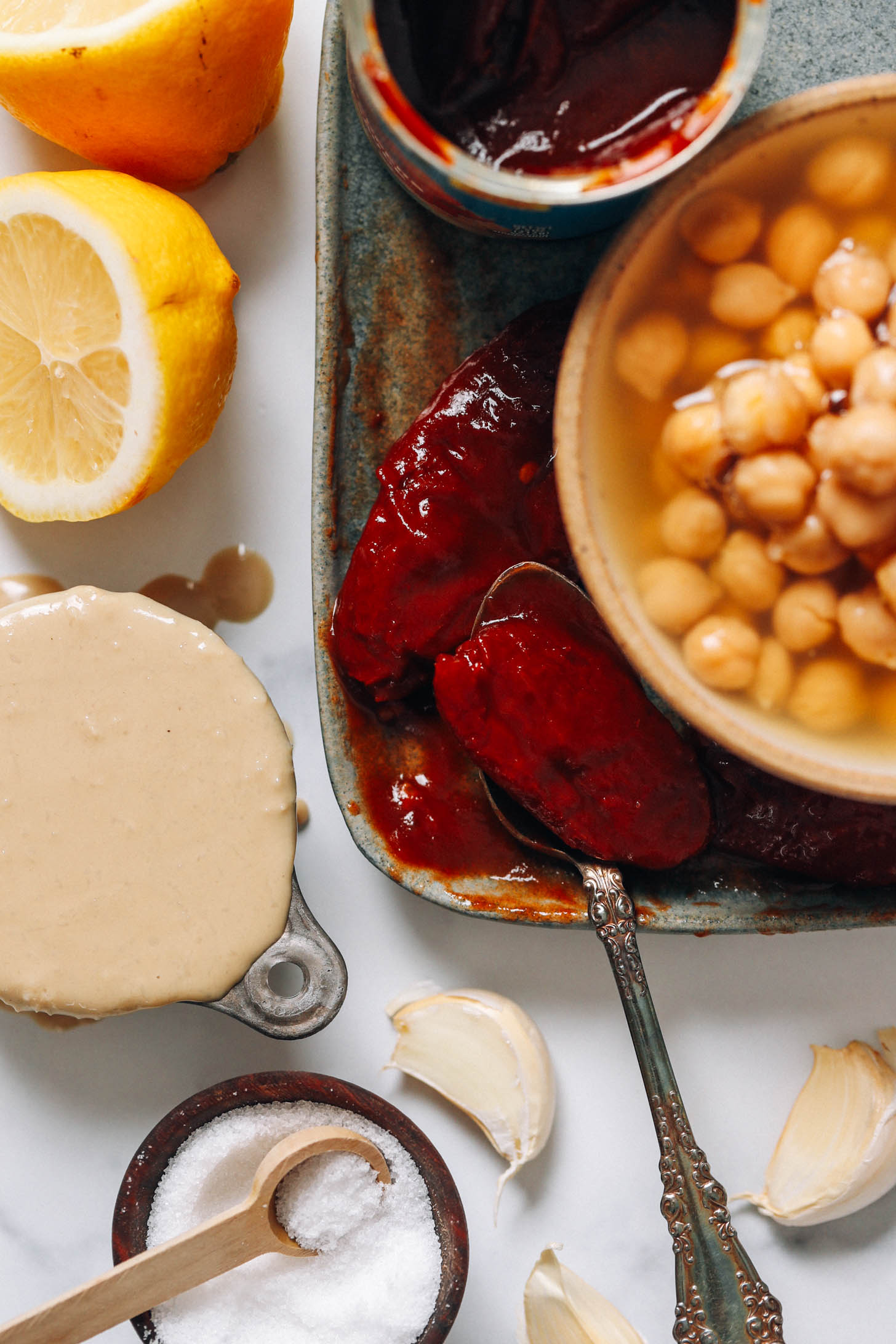 Lemons, tahini, salt, garlic cloves, chipotle peppers in adobo sauce, and chickpeas