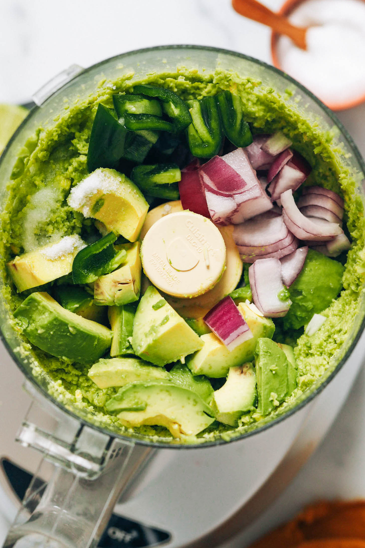 Avocados, red onion, jalapeno, salt, and lime juice in a food processor