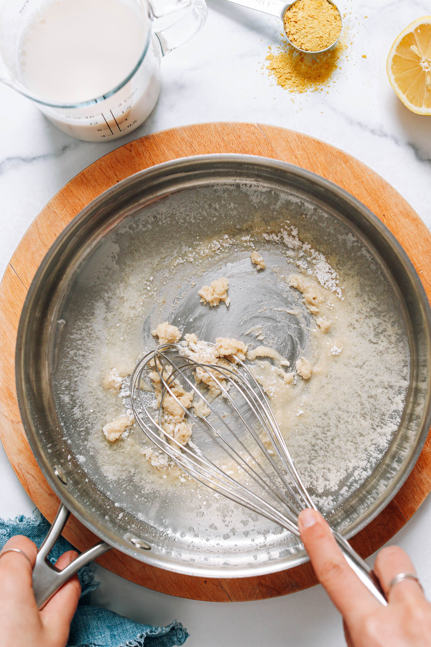 Whisking gluten-free flour and vegan butter to make a roux