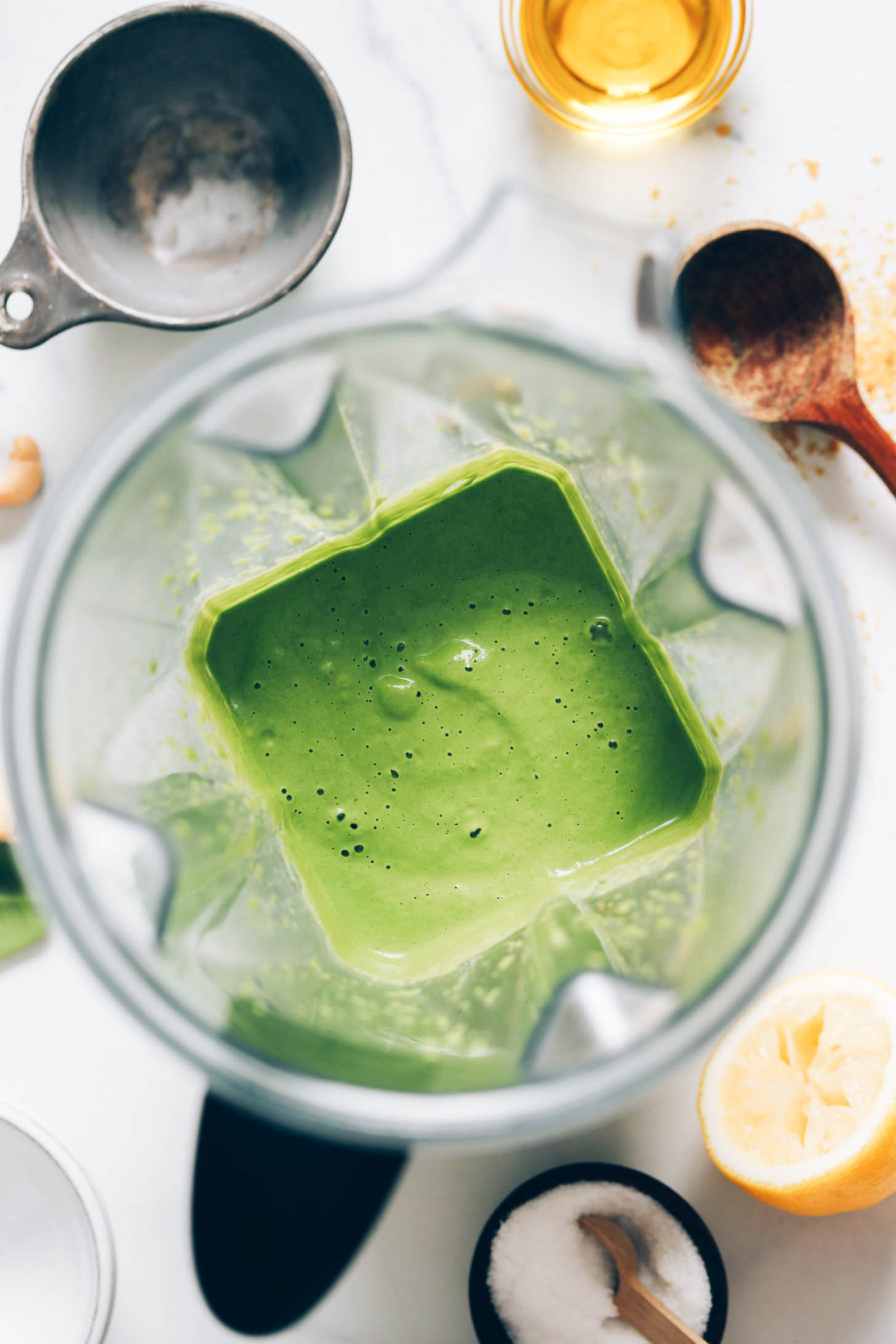 Creamy green pesto sauce in a blender