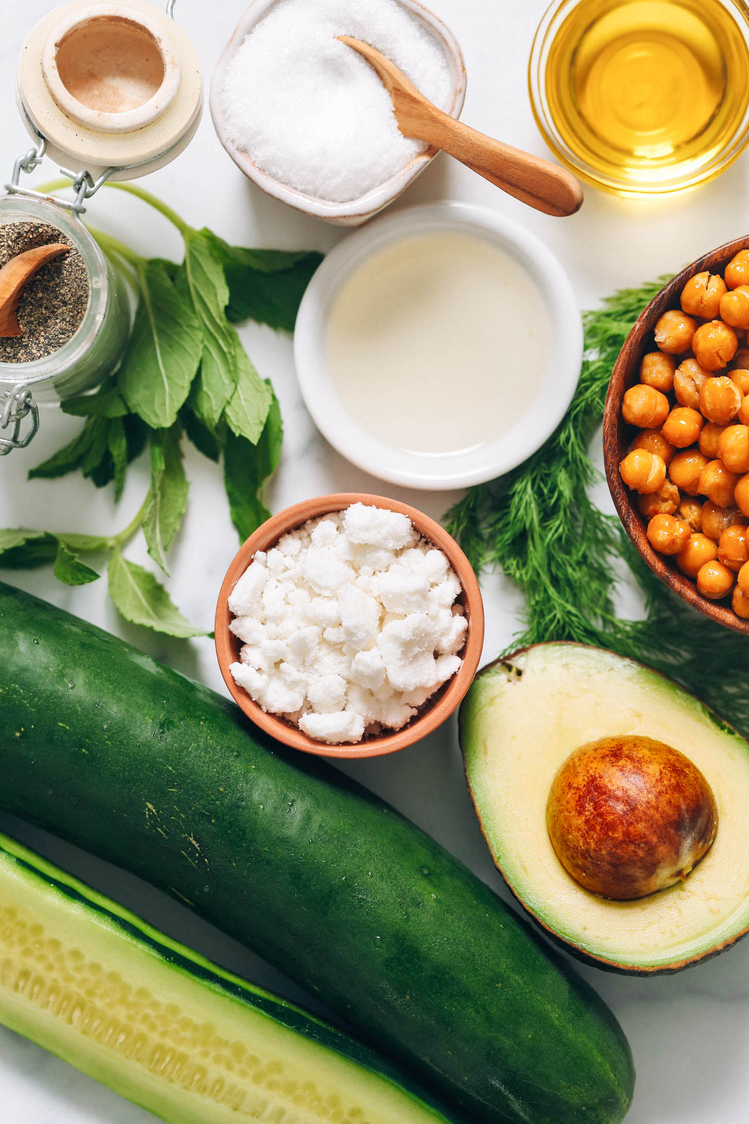 Olive oil, salt, pepper, mint, white balsamic vinegar, dill, chickpeas, avocado, vegan feta, and cucumber