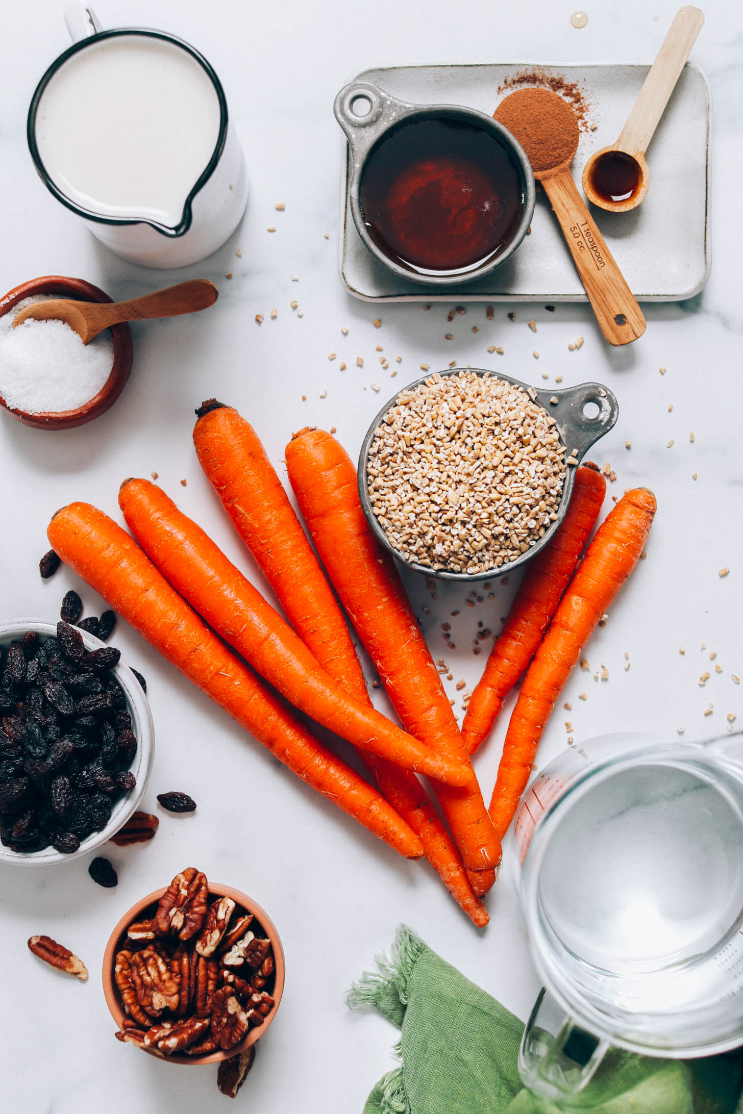 Carrots, steel cut oats, water, pecans, raisins, salt, dairy-free milk, maple syrup, cinnamon, and vanilla