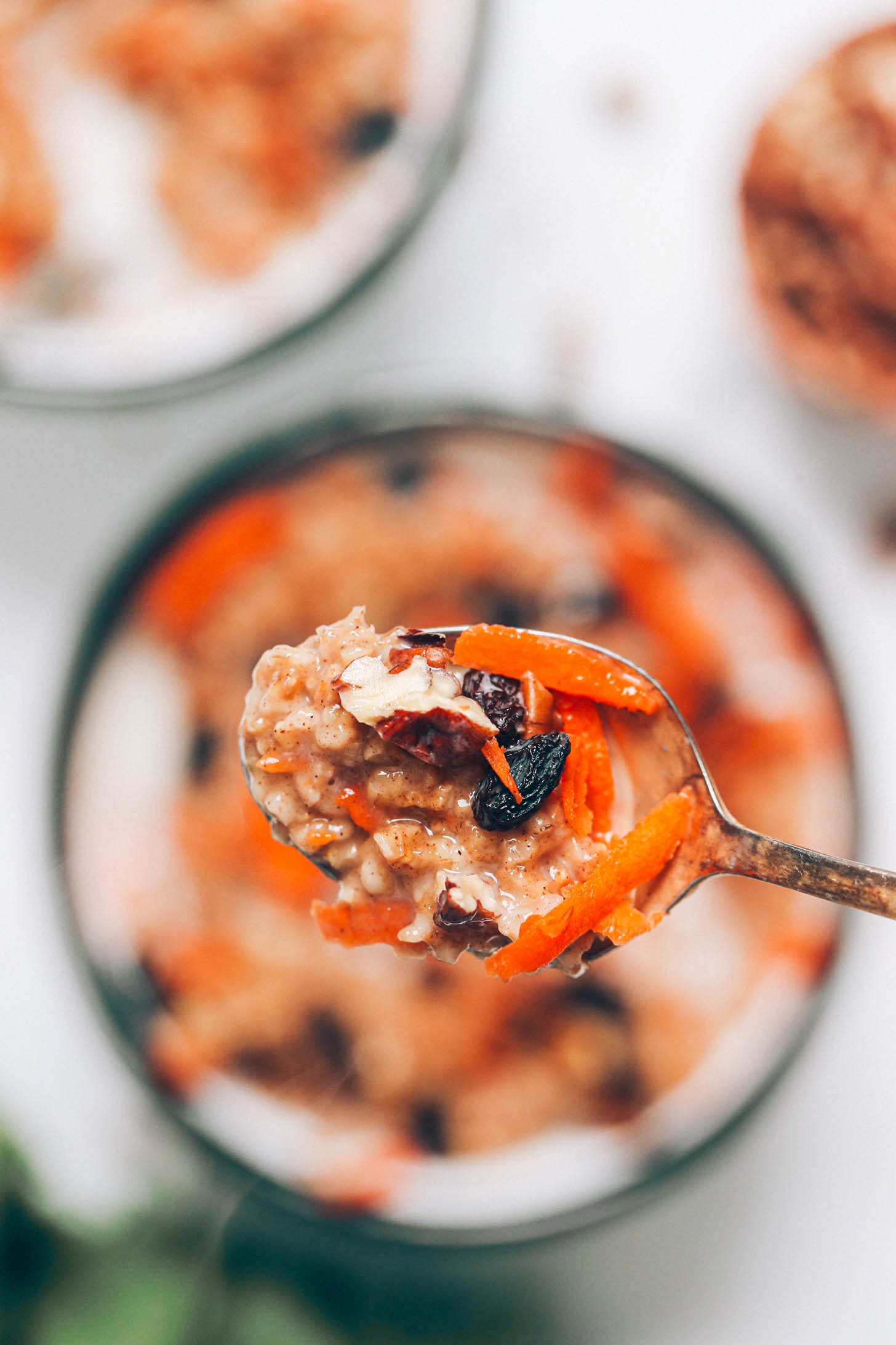Holding a spoonful of carrot cake oatmeal over a bowl