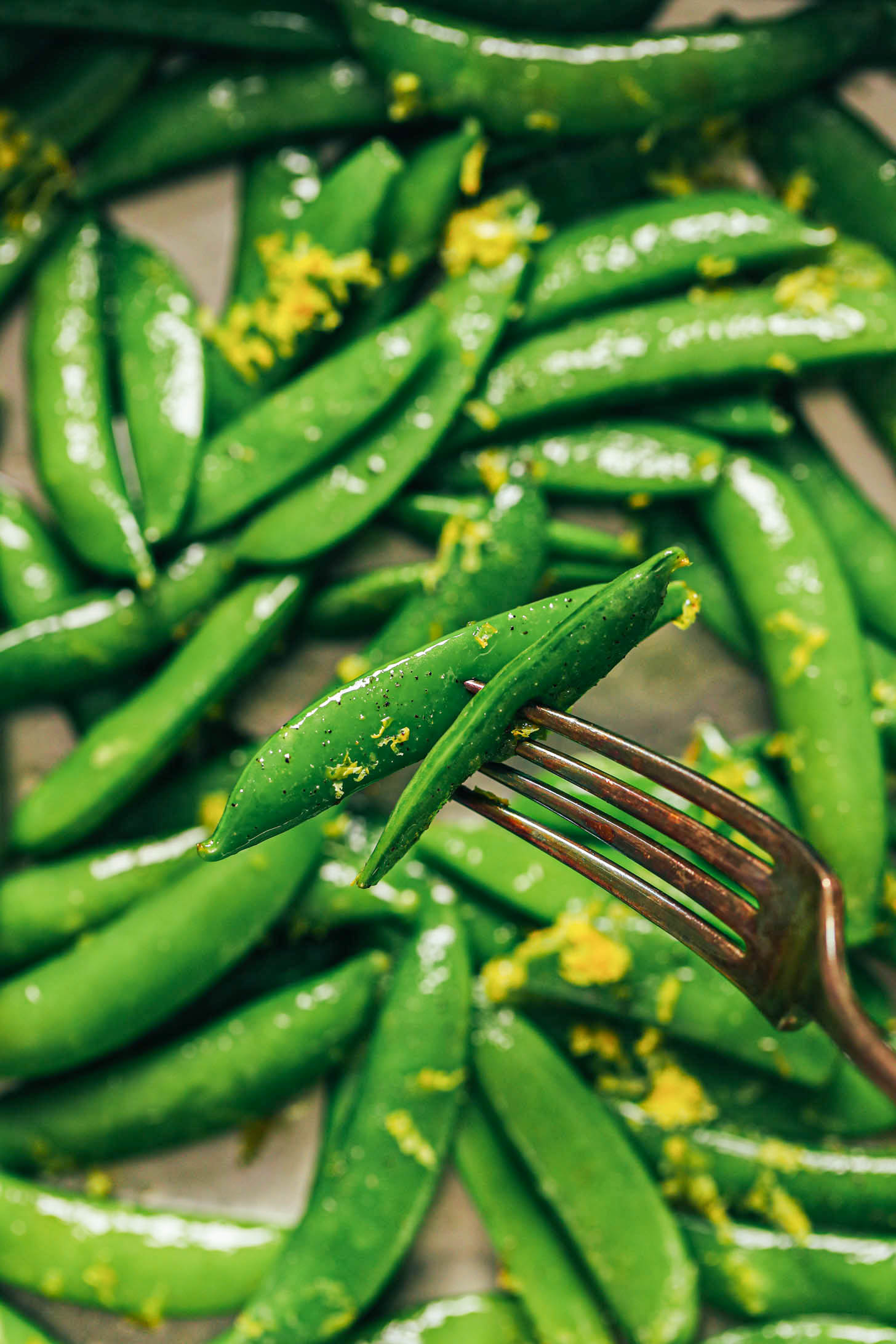 Close up shot of snap peas on a fork
