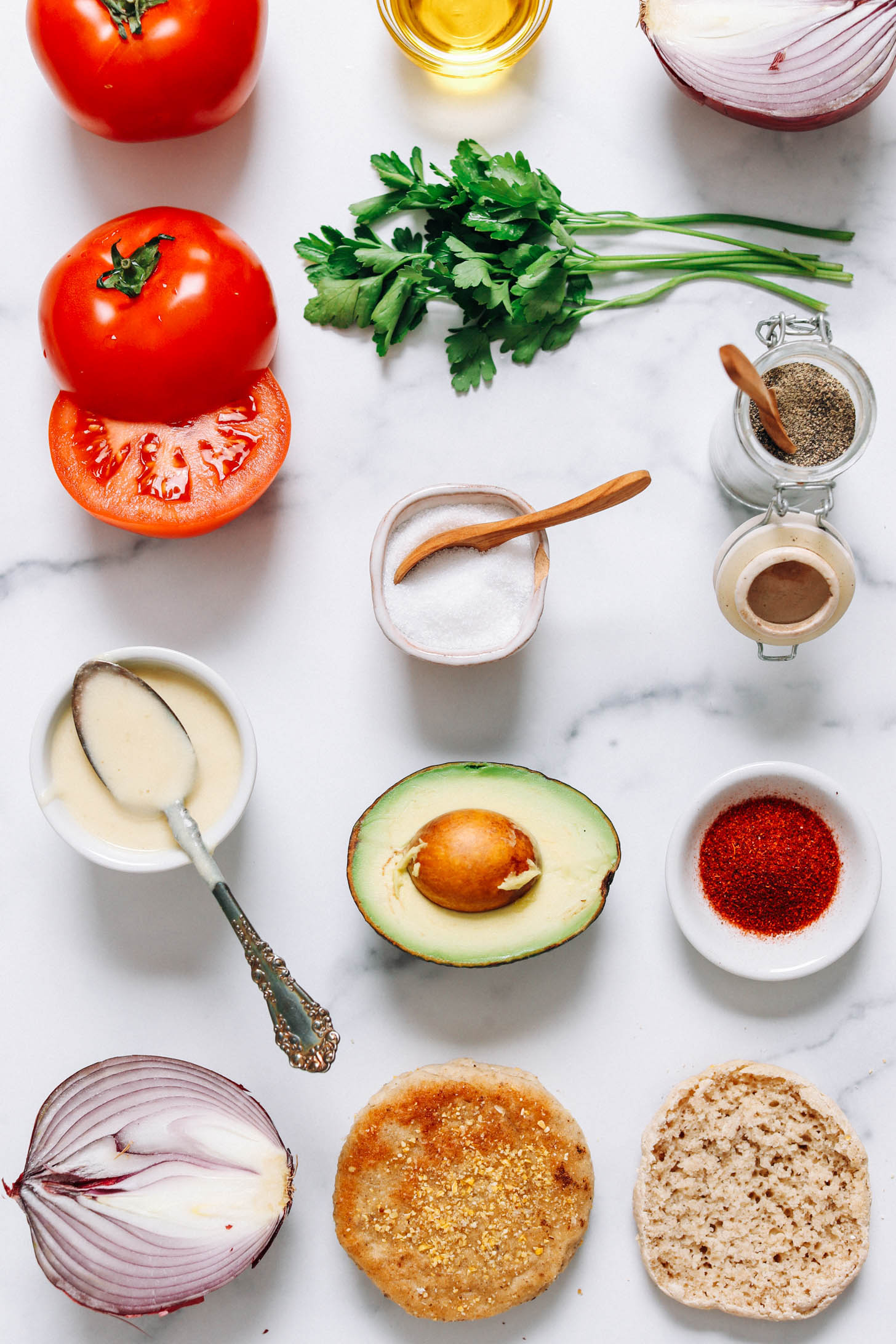 Tomatoes, parsley, red onion, oil, salt, pepper, vegan hollandaise sauce, avocado, smoked paprika, and English muffins