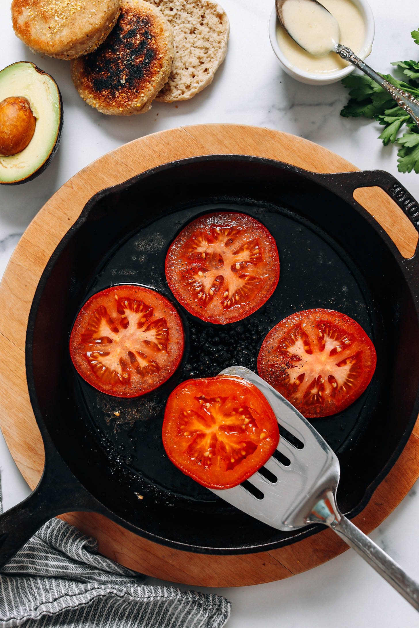 Searing sliced tomatoes in a cast iron skillet