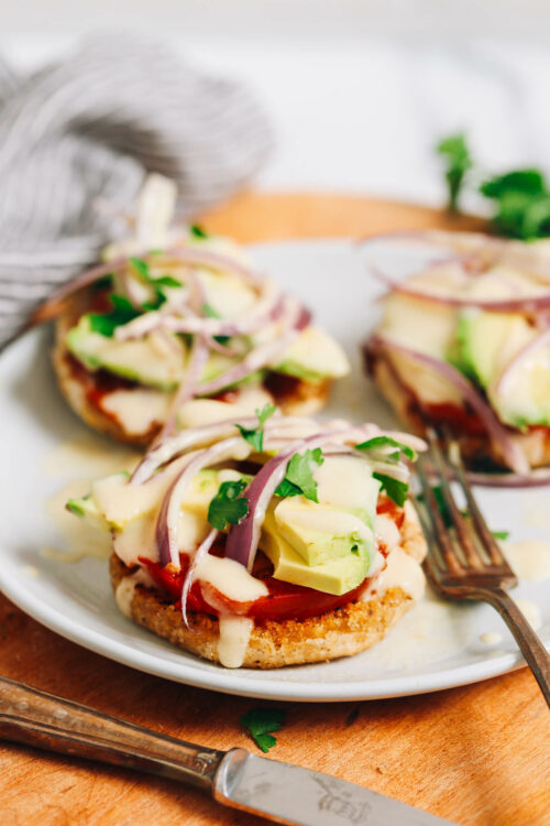 Fork on a plate with vegan eggs Benedicts
