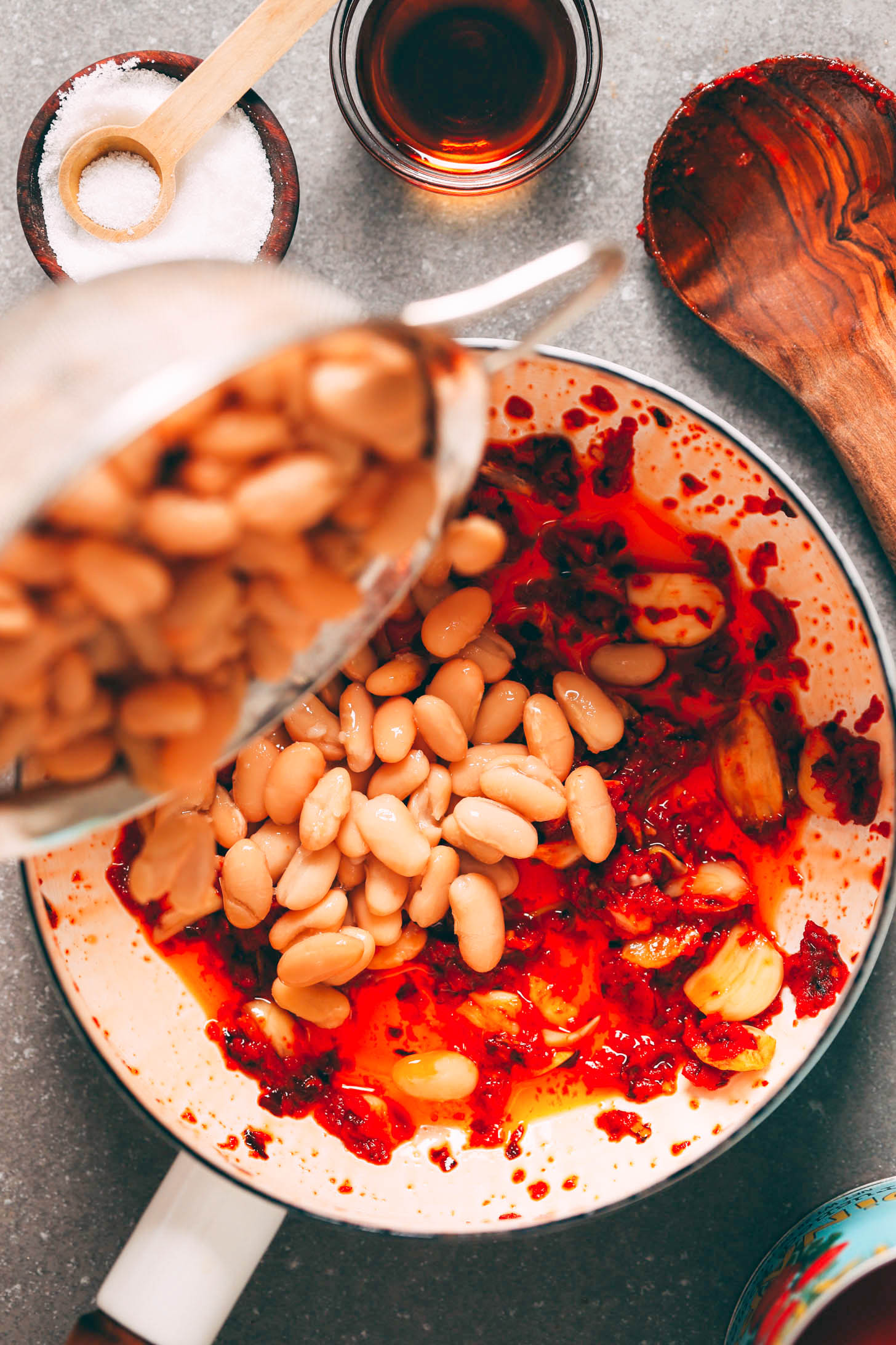 Adding white beans to a pot