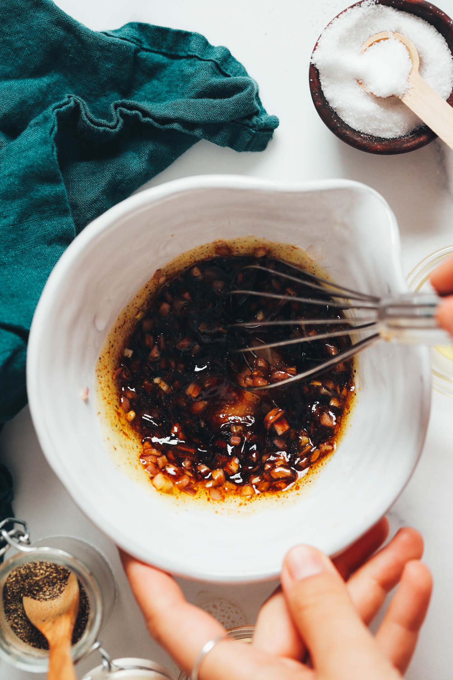 Whisking homemade balsamic vinaigrette in a bowl