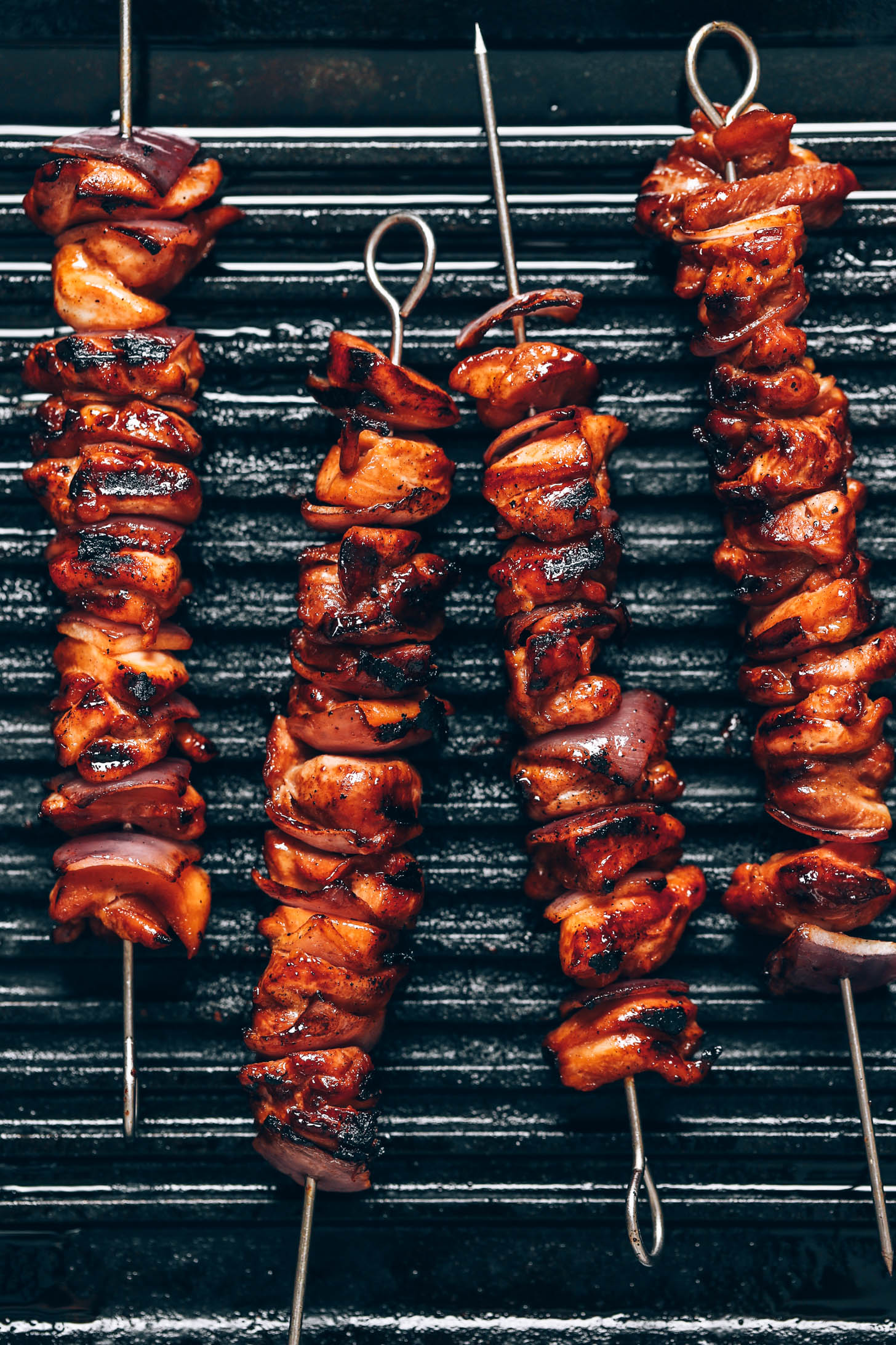 Chicken kebabs grilling on a grill pan