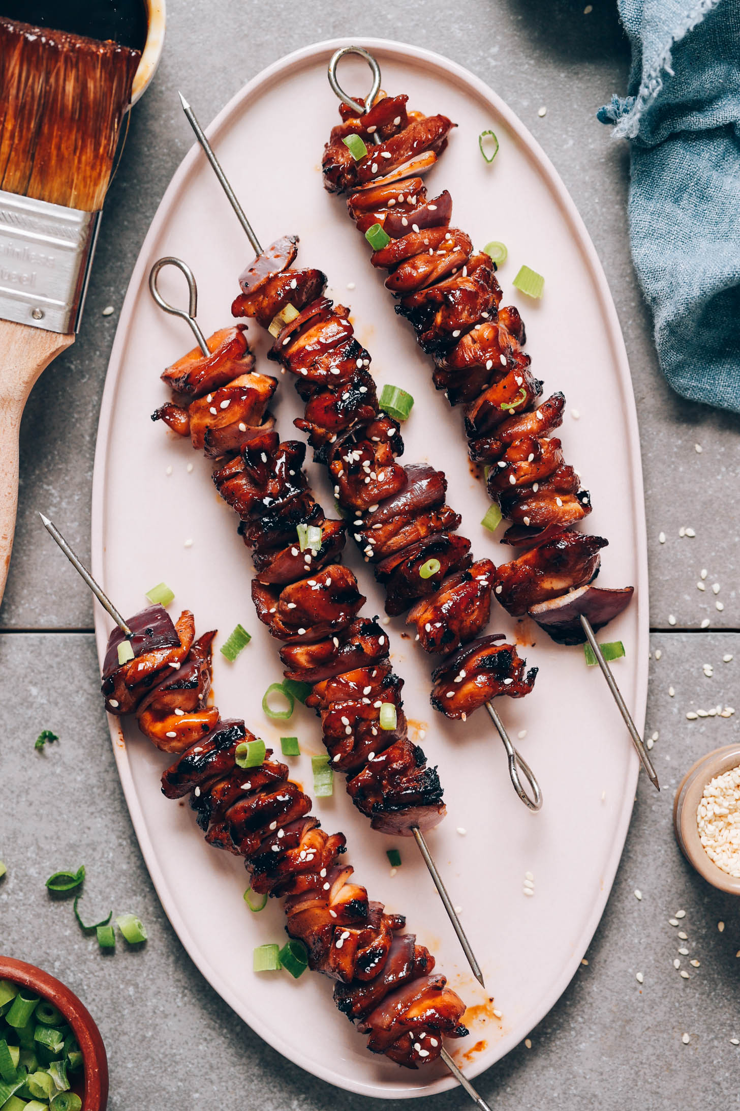 Teriyaki glaze next to a platter of Grilled Teriyaki Chicken Skewers