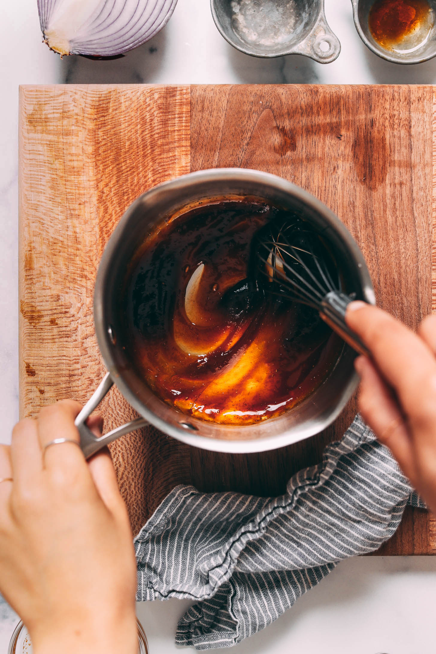 Whisking a teriyaki glaze in a saucepan