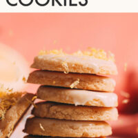 Stack of easy vegan and gluten-free lemon cookies with frosting and lemon zest on top