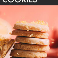 Stack of easy vegan and gluten-free lemon cookies with frosting and lemon zest on top