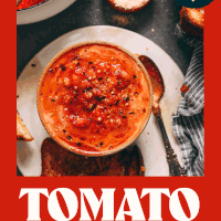 Overhead shot of a bowl of super garlicky vegan tomato soup with smashed white beans