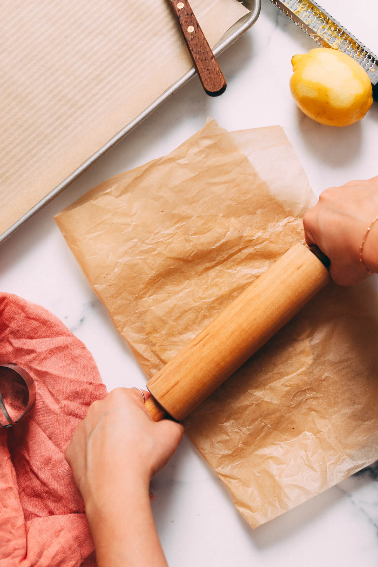 Rolling out cookie dough between two sheets of parchment paper