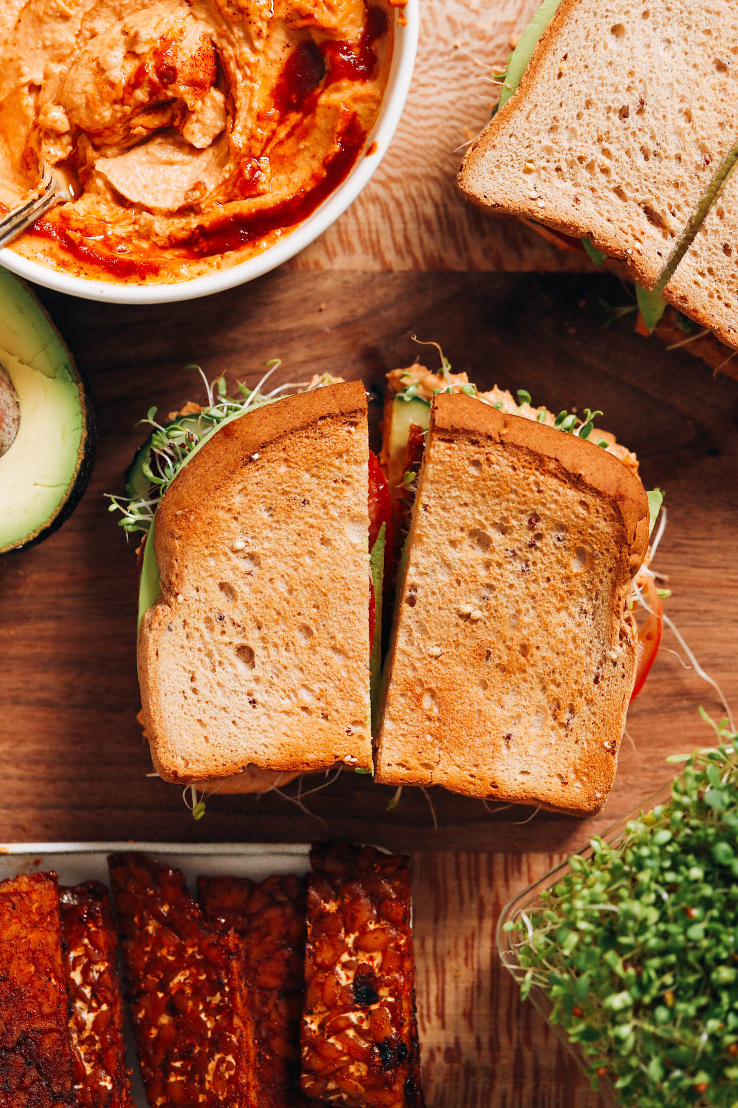 Chipotle hummus, sandwiches, tempeh, avocado, and alfalfa sprouts