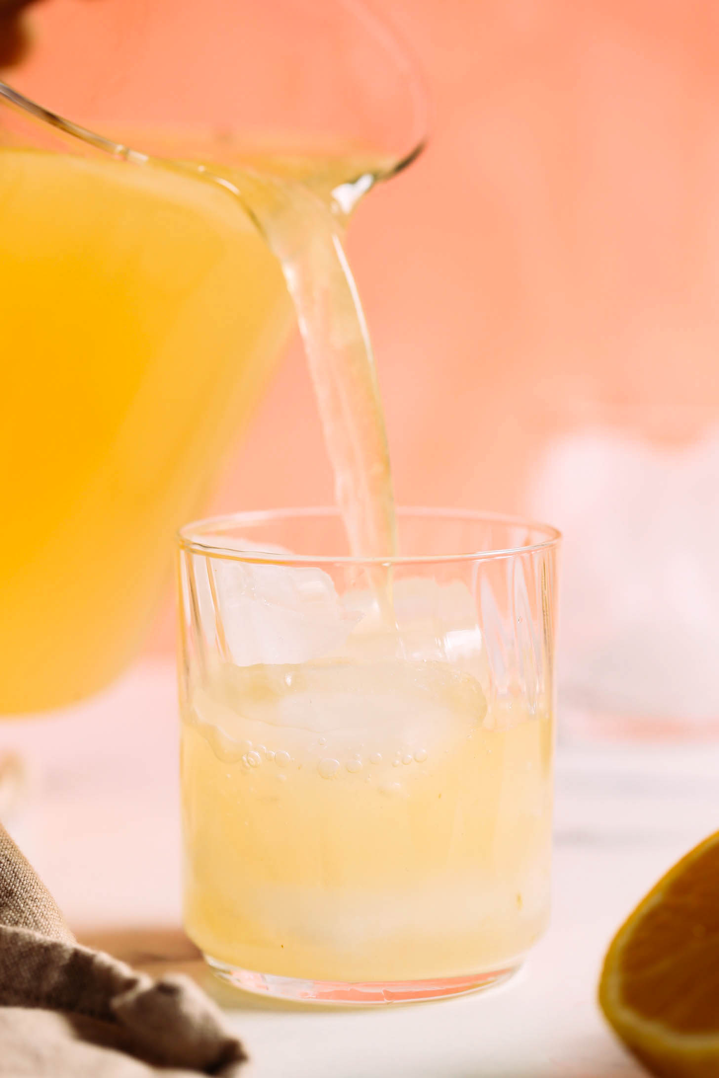 Pouring lemonade over ice