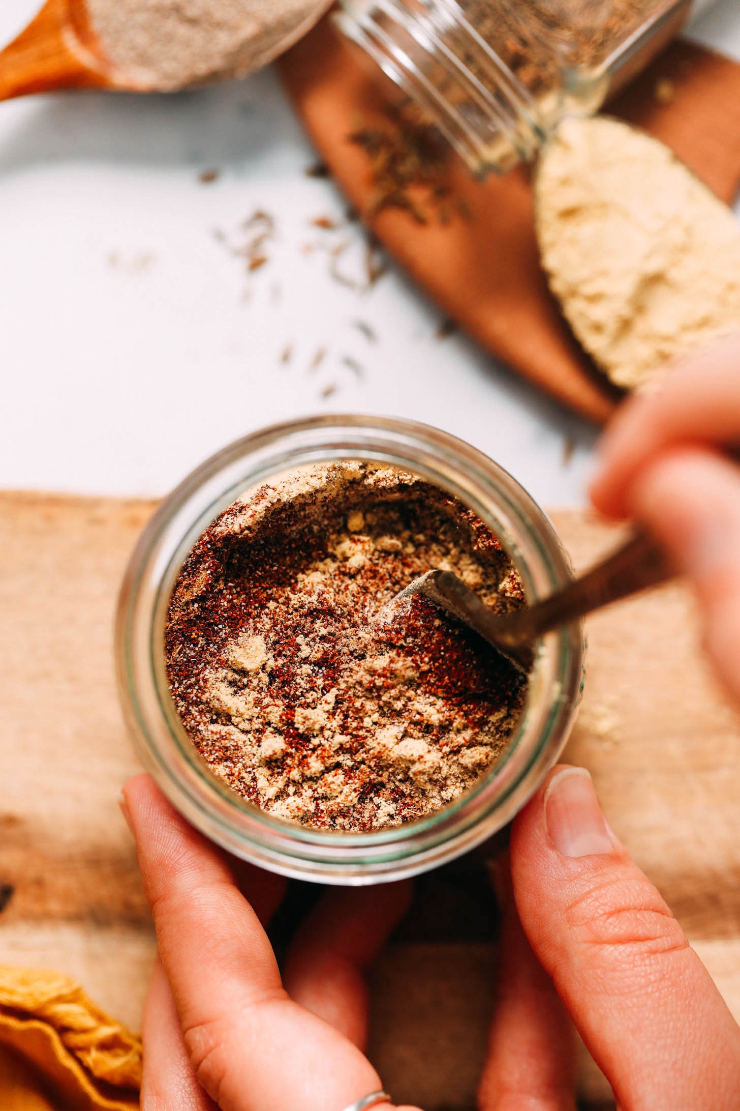 Using a fork to mix spices in a jar