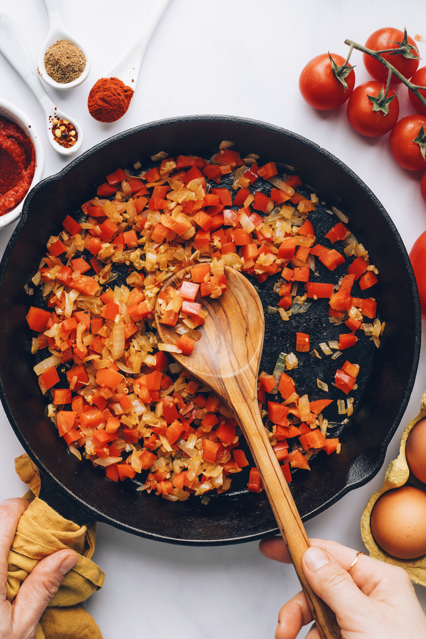 Cast iron skillet of sautéed onion, red bell pepper, and garlic