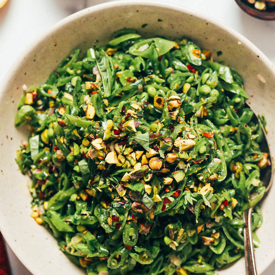 Serving plate piled high with snap pea salad