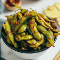Close up shot of a bowl of spicy garlic edamame