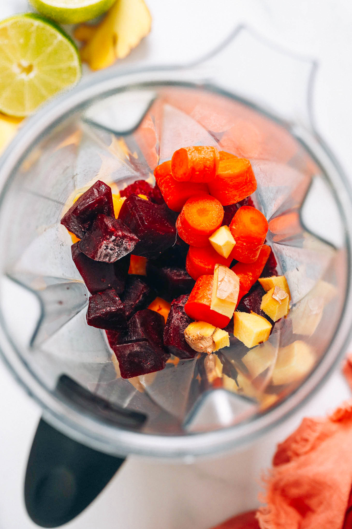 Carrots, ginger, beets, raspberries and mango in a blender