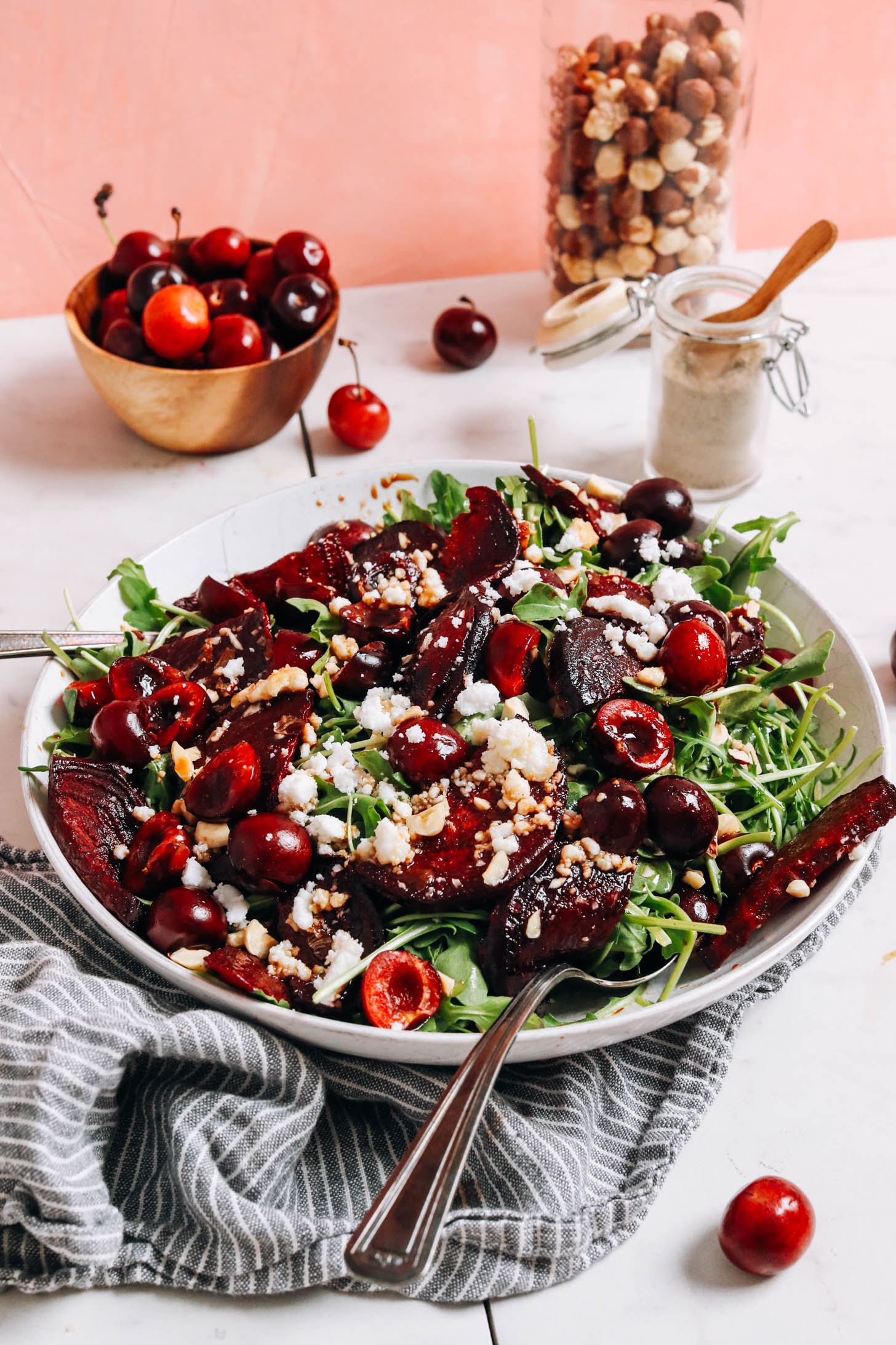 Hazelnuts, cherries, and black pepper next to a bowl of our roasted beet salad