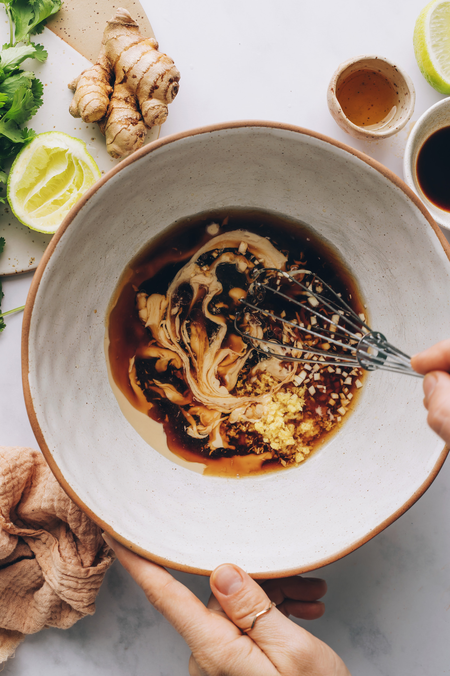 Whisking homemade sesame dressing in a bowl